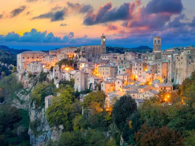 Panoramic view of Sorano in the evening sunset with old tradition buildings and illumination. Old small town in the Province of Grosseto, Tuscany (Toscana), Italy.