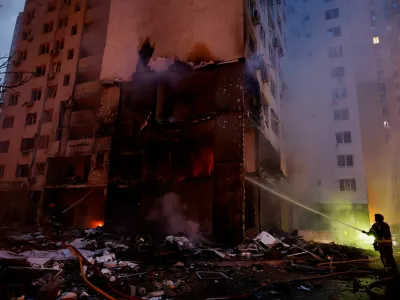 Firefighters work at the site of an apartment building, which was heavily damaged during Russian missile and drone strikes, amid Russia's attack on Ukraine, in Kyiv, Ukraine, July 6, 2026. REUTERS/Valentyn Ogirenko   TPX IMAGES OF THE DAY