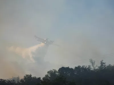 A firefighting plane drops water, following a wildfire in Ille-sur-Tet near Perpignan, France, July 6, 2026. REUTERS/Bruna Casas
