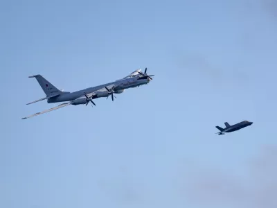 Royal Navy F-35B fighter, right, of UK Carrier Strike Group launches from HMS Prince of Wales to intercept a Russian military aircraft, Thursday July 2, 2026. (Chris Sellars/Ministry of Defence via AP)