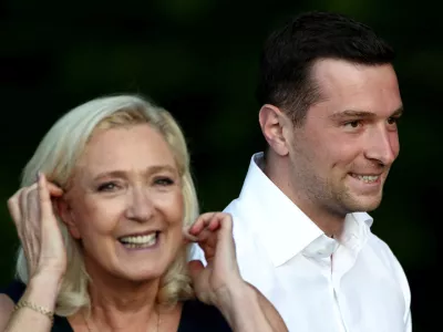 French far-right leader Marine Le Pen and Jordan Bardella, president of the French far-right Rassemblement National (National Rally - RN) political party, react after speaking at a country fair with supporters in Lievin, northern France, July 4, 2026. REUTERS/Tom Nicholson