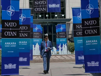 A man walks past NATO banners near the Bestepe Presidential complex ahead of the NATO Summit in Ankara, Turkey, Monday, July 6, 2026. (AP Photo/Hussein Malla)