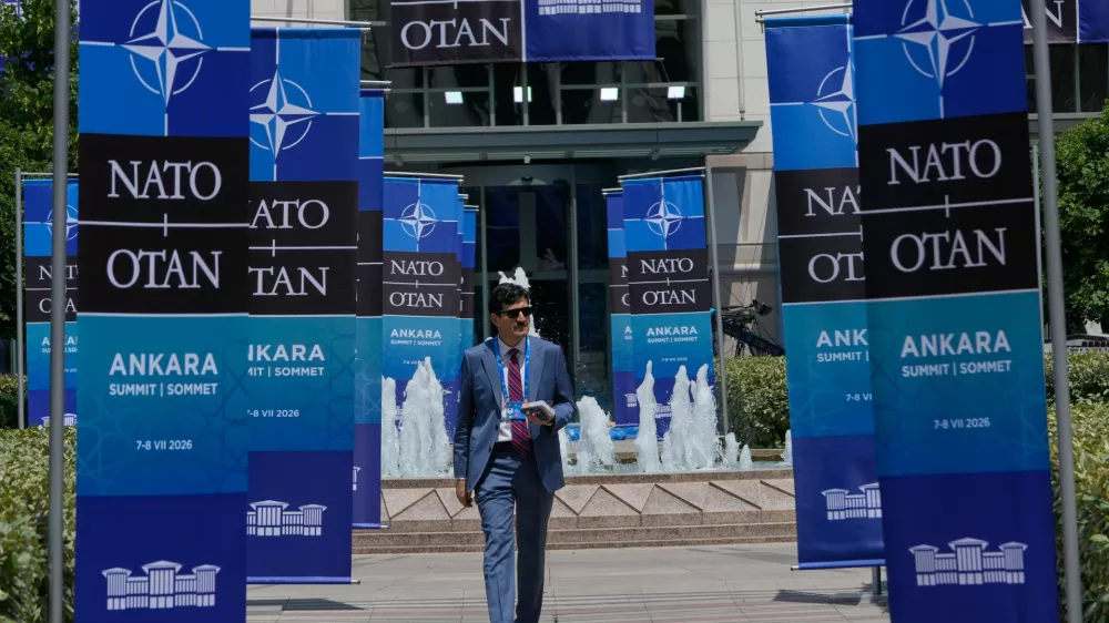 A man walks past NATO banners near the Bestepe Presidential complex ahead of the NATO Summit in Ankara, Turkey, Monday, July 6, 2026. (AP Photo/Hussein Malla)