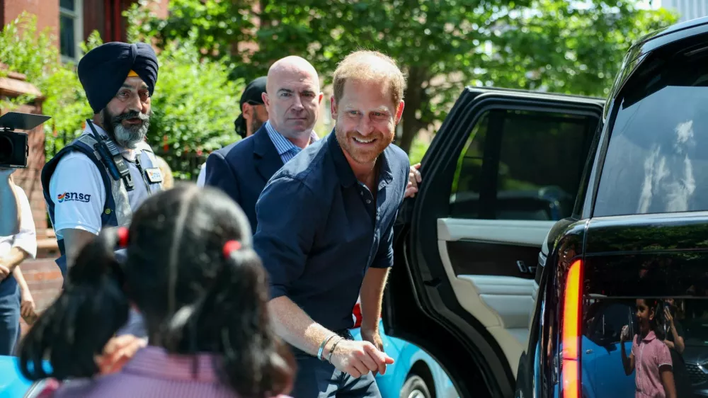 Britain's Prince Harry greets a child as he leaves the Birmingham Children's Hospital after celebrating the 20th anniversary of the first WellChild Nurse programme, in Birmingham, Britain, July 9, 2026. REUTERS/Isabel Infantes    TPX IMAGES OF THE DAY