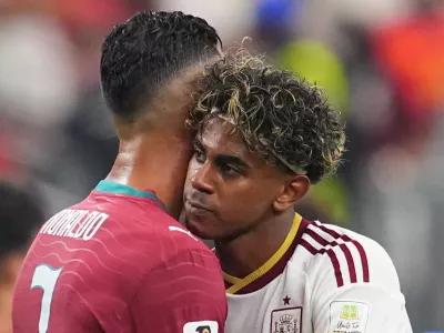 Spain's Lamine Yamal, right, hugs Portugal's Cristiano Ronaldo (7) after the World Cup round of 16 soccer match between Portugal and Spain in Arlington, Texas, near Dallas, Monday, July 6, 2026. (AP Photo/Julio Cortez)