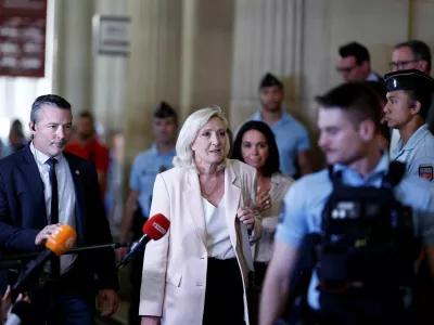 French far-right leader Marine Le Pen, member of parliament for the Rassemblement National (National Rally - RN) party, leaves after the verdict in her appeal trial, alongside the RN party itself and 10 others defendants found guilty of diverting European Parliament funds, at the Paris courthouse on the Ile de la Cite, in Paris, France, July 7, 2026. REUTERS/Benoit Tessier