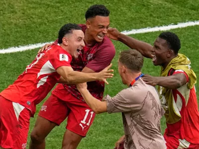 Switzerland's Ruben Vargas, left, reacts with teammates after scoring the winning shot in a shootout during the World Cup round of 16 soccer match in Vancouver, British Columbia, Tuesday, July 7, 2026. (AP Photo/Gregory Bull)
