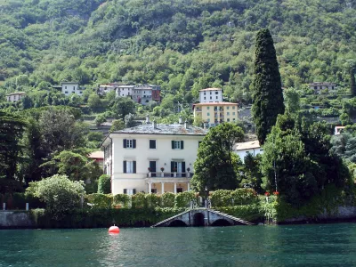 ** FILE ** A lakeside view of George Clooney's villa Oleandra in Laglio, on Lake Como, northern Italy, on July 8, 2004. U.S. film star George Clooney has joined a protest to stop construction of parking lots and a promenade in the northern Italian lakeside town where he owns a villa because he fears his presence is turning the quiet town into a tourist attraction, Friday, July 22, 2007.. (AP Photo/Antonio Calanni, files)