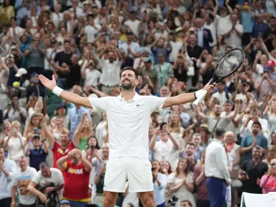 Novak Djokovic of Serbia celebrates winning against Felix Auger-Aliassime of Canada in their quarter-final men's singles match at the Wimbledon Tennis Championships in London, Tuesday, July 7, 2026. (AP Photo/Maja Smiejkowska)