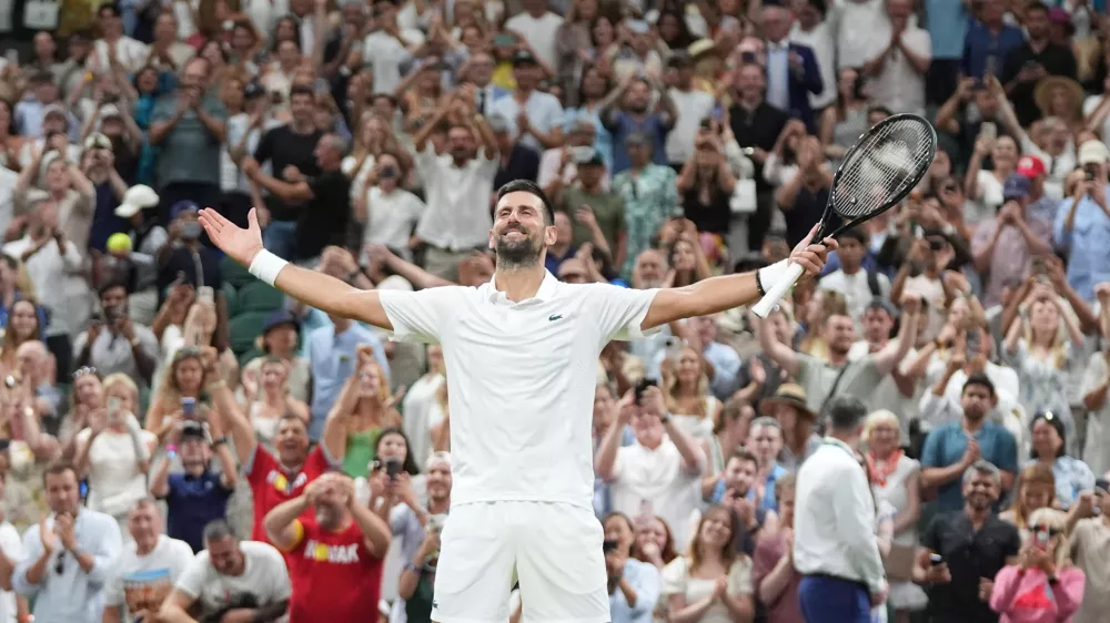 Novak Djokovic of Serbia celebrates winning against Felix Auger-Aliassime of Canada in their quarter-final men's singles match at the Wimbledon Tennis Championships in London, Tuesday, July 7, 2026. (AP Photo/Maja Smiejkowska)