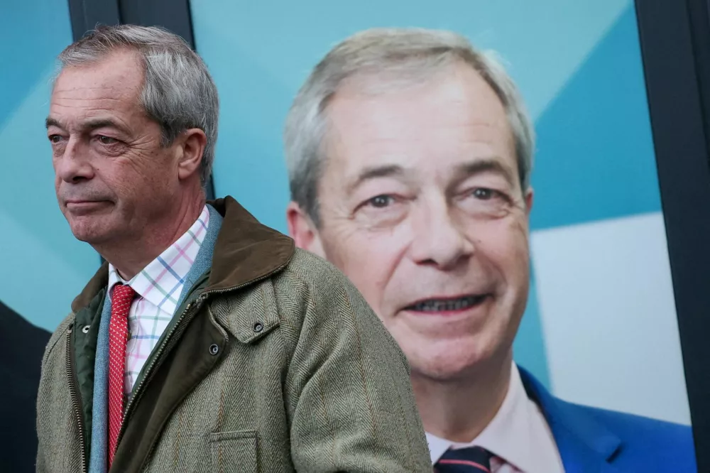 FILE PHOTO: Reform UK party leader Nigel Farage attends the opening of the party's campaign headquarters ahead of the Gorton and Denton by-election, triggered by the resignation of Andrew Gwynne, in Denton, Britain, February 5, 2026. REUTERS/Phil Noble/File Photo