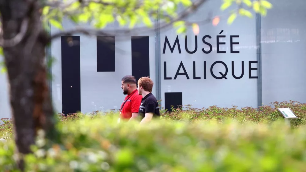 Security members walk past the Musee Lalique, the museum holding works by French luxury glassmaker Rene Lalique, which will remain closed for several days after a theft in which around 20 items of jewellery worth several million euros were stolen on Sunday morning, in Wingen-sur-Moder, eastern France, July 6, 2026. REUTERS/Abdul Saboor