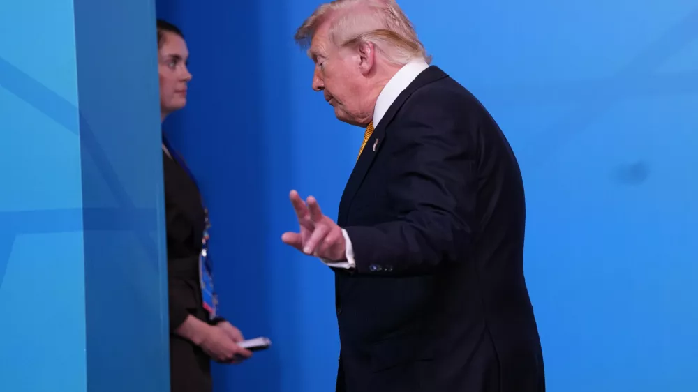President Donald Trump walks off the podium after a group photo of NATO heads of state and government during the NATO summit in Ankara, Turkey, Wednesday, July 8, 2026. (AP Photo/Francisco Seco)