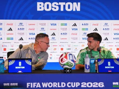 Morocco head coach Mohamed Ouahbi and Morocco's Brahim Diaz (10) talk to the media during a press conference ahead of the World Cup quarterfinal soccer match between France and Morocco in Foxborough, Mass., near Boston, Wednesday, July 8, 2026. (AP Photo/Martin Meissner)