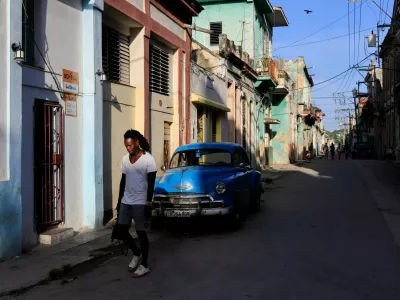A man walks past a vintage car ahead of an announcement by Cuba's grid operator UNE that it had reconnected most of the country to the national grid, though millions remained without power as the country struggles to generate even one-third of current demand amid an ongoing U.S. fuel blockade, in Havana, Cuba, July 7, 2026. REUTERS/Norlys Perez