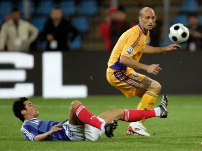FILE - France's Yoann Gourcuff challenges for the ball with Romania's Gabriel Muresan, right, during their World Cup group 7 qualifying soccer match at Farul Stadium in Constanta, Romania Saturday Oct. 11, 2008. (AP Photo/Francois Mori, File)