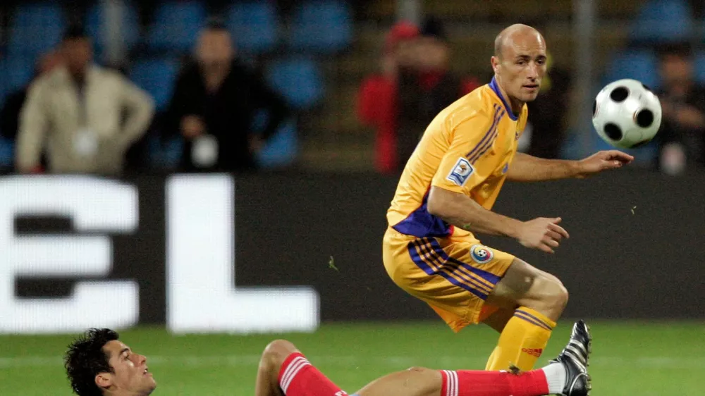 FILE - France's Yoann Gourcuff challenges for the ball with Romania's Gabriel Muresan, right, during their World Cup group 7 qualifying soccer match at Farul Stadium in Constanta, Romania Saturday Oct. 11, 2008. (AP Photo/Francois Mori, File)