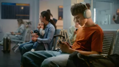 Crowded International Airport Terminal: Teenager in Headphones Using Phone, Woman Sitting with Little Baby. Diverse People and Passengers Waiting for Airplane Flight in Boarding Lounge of Airline Hub.,Image: 997414667, License: Royalty-free, Restrictions:, Model Release: no 