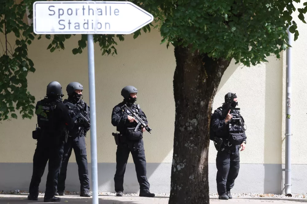Heavily armed police officers guard at the Welfen High School, Schongau, Germany, Wednesday, July 8, 2026. (Karl-Josef Hildenbrand/dpa via AP)