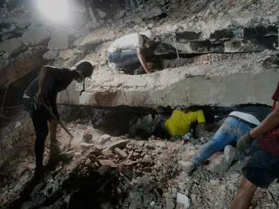 The family Nunez search for a relative in the debris of collapsed building by the earthquakes in La Guaira, Venezuela, Thursday, July 9, 2026. (AP Photo/Ariana Cubillos)