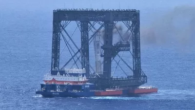 In this photo released by Xinhua News Agency, a drone photo shows the successful capture of the returned first stage of Long March-10B carrier rocket on a seaborne platform via a net-capture system near Wenchang in southern China's Hainan province on Friday, July 10, 2026. (Xing Guangli/Xinhua News Agency via AP)