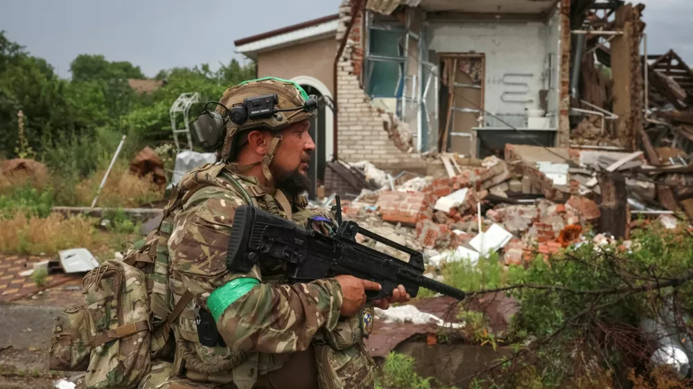 A serviceman of the 49th Separate Assault Battalion Carpathian Sich of the Ukrainian Armed Forces patrols an area during his combat mission, amid Russia's attack on Ukraine, in the frontline town of Druzhkivka, in Donetsk region, Ukraine July 9, 2026. REUTERS/Anatolii Stepanov