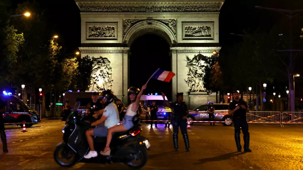 Soccer Football - FIFA World Cup 2026 - Quarter Final - France v Morocco - Fans gather in Paris - Paris, France - July 9, 2026 France fans celebrate at Champs-Elysees after the match REUTERS/Abdul Saboor