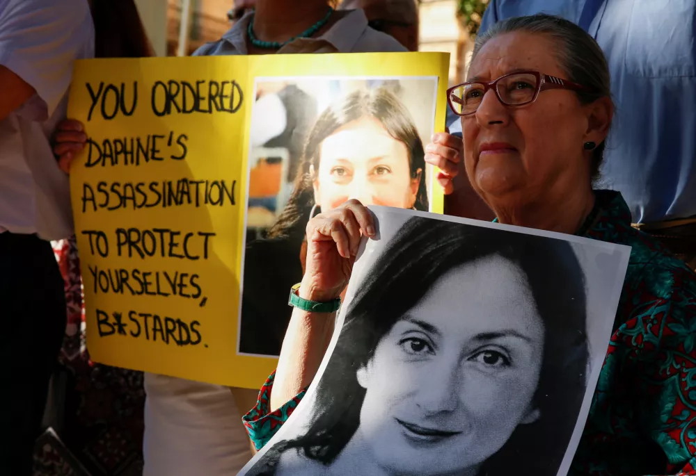 Rose Vella holds up a photo of her daugther, anti-corruption journalist Daphne Caruana Galizia during a protest and vigil marking twenty-one months since her assassination, after three men were indicted for her murder, in Valletta, Malta July 16, 2019. REUTERS/Darrin Zammit Lupi