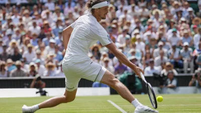 Alexander Zverev of Germany stretches as he plays a return to Arthur Fery of Britain during their men's singles semifinal match at the Wimbledon Tennis Championships in London, Friday, July 10, 2026. (AP Photo/Kirsty Wigglesworth)