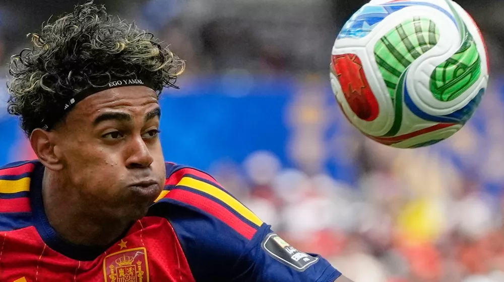 Spain's Lamine Yamal (19), wearing a headband that says 'Ego Yamal', controls the ball during the World Cup quarterfinal soccer match between Spain and Belgium in Inglewood, Calif., near Los Angeles, Friday, July 10, 2026. (AP Photo/Andre Penner)