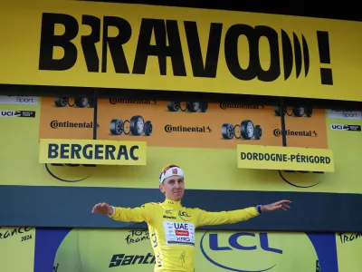 Cycling - Tour de France - Stage 8 - Perigueux to Bergerac - Bergerac, France - July 11, 2026 UAE Team Emirates XRG's Tadej Pogacar celebrates on the podium wearing the yellow jersey after stage 8 REUTERS/Stephanie Lecocq
