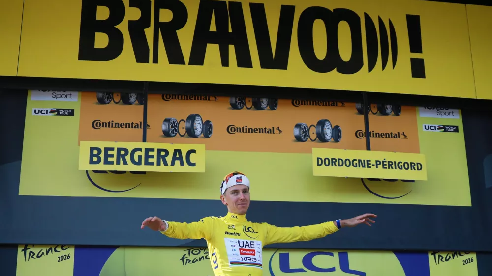 Cycling - Tour de France - Stage 8 - Perigueux to Bergerac - Bergerac, France - July 11, 2026 UAE Team Emirates XRG's Tadej Pogacar celebrates on the podium wearing the yellow jersey after stage 8 REUTERS/Stephanie Lecocq