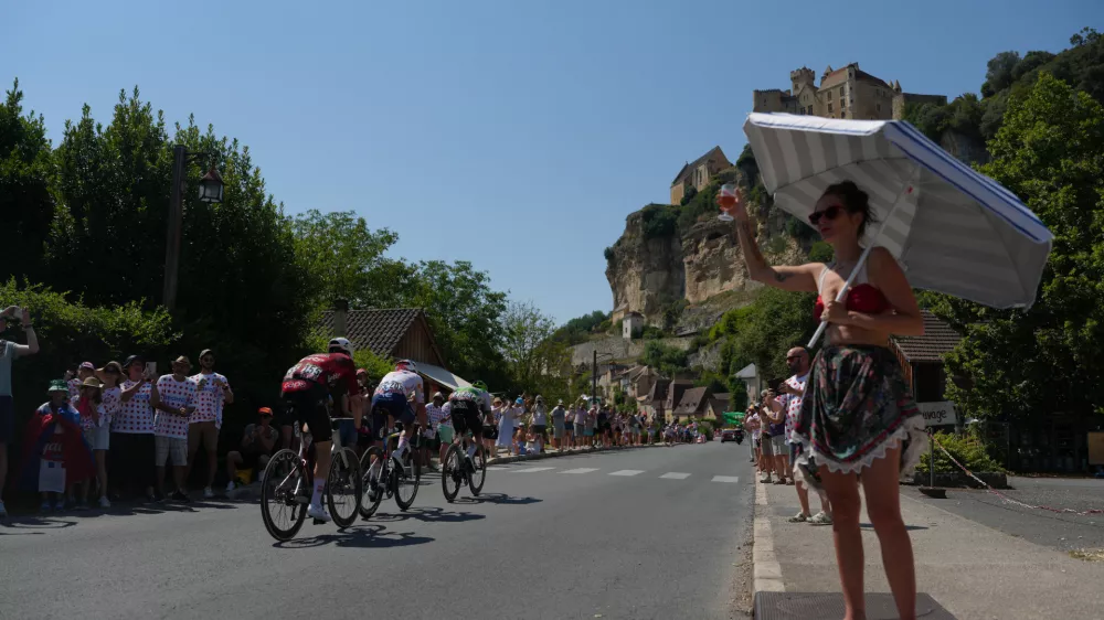 Spectators cheer as breakaway riders race past them during the eighth stage of the Tour de France cycling race of over 180.4 kilometers (about 112 miles) with start in Perigueux and finish in Bergerac, France, Saturday, July 11, 2026. (AP Photo/Thibault Camus)