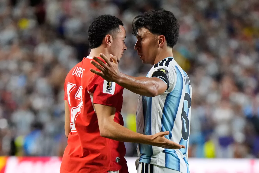 Switzerland's Ruben Vargas (17) and Argentina's Lisandro Martinez (6) react during the World Cup quarterfinal soccer match between Argentina and Switzerland in Kansas City, Mo., Saturday, July 11, 2026. (AP Photo/Ashley Landis)