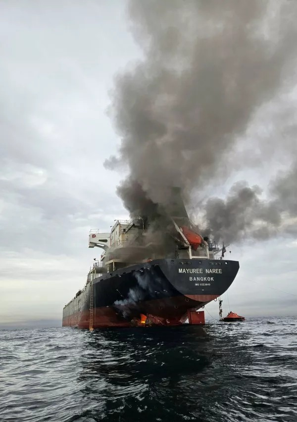 Smoke billows from the Mayuree Naree, a Thailand-flagged bulk carrier, after it was hit by a projectile in the Strait of Hormuz, north of Oman, on March 11, 2026. (Noppadon Wongsuvan via AP) CORRECTION: Corrects photographer name from Panithi Tumkaew to Noppadon Wongsuvan)