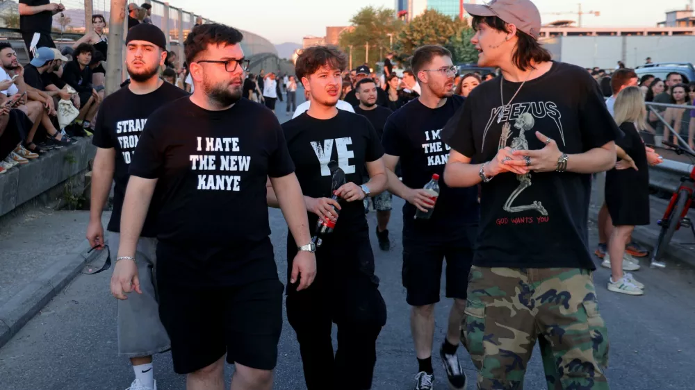Concertgoers walk to a venue where Ye, the rapper formerly known as Kanye West, will perform in Tirana, Albania, Saturday, July 11, 2026. (AP Photo/Hameraldi Agolli)