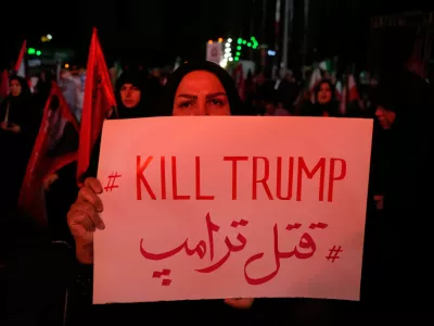 A pro-government demonstrator holds an anti-Trump placard in a gathering commemorating the late Iranian Supreme Leader Ayatollah Ali Khamenei at a square in Tehran, Saturday, July 11, 2026. (AP Photo/Vahid Salemi)