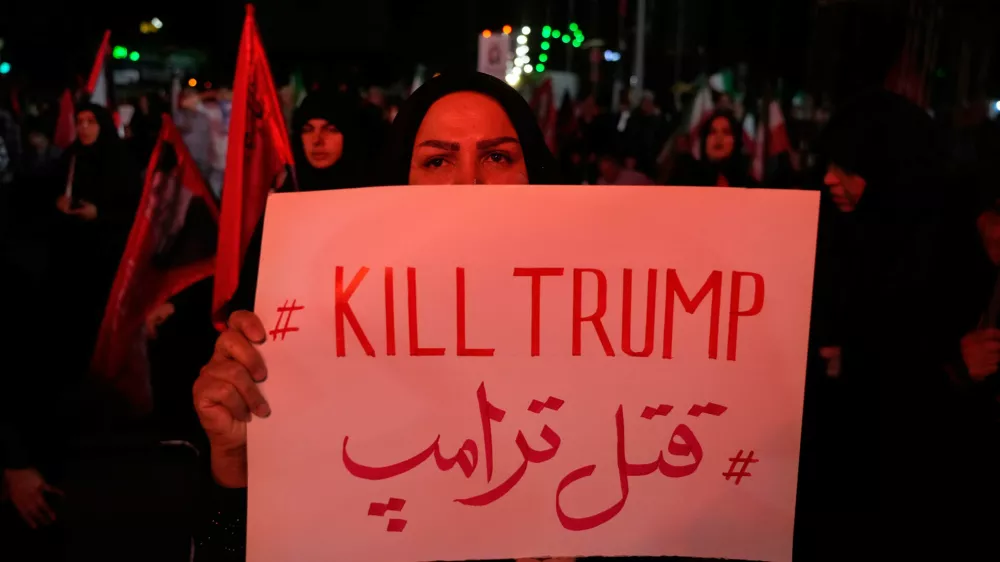 A pro-government demonstrator holds an anti-Trump placard in a gathering commemorating the late Iranian Supreme Leader Ayatollah Ali Khamenei at a square in Tehran, Saturday, July 11, 2026. (AP Photo/Vahid Salemi)