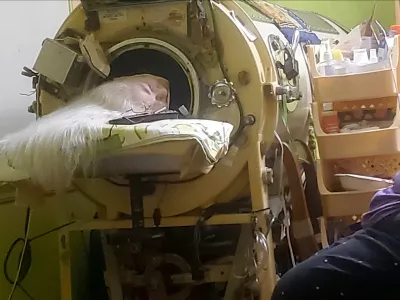 In this photo provided by Cindy McVey, her sister Martha Lillard rests in her iron lung on Friday, February 6, 2026 in Shawnee, Okla. (Cindy McVey via AP)