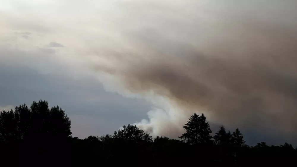 Smoke rises from a wildfire, as French firefighters battle the blaze in the Fontainebleau forest in in Noisy-sur-Ecole near Paris, amid a heatwave affecting a large part of the country, France, July 13, 2026. REUTERS/Benoit Tessier
