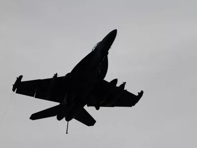 An F-18 fighter jet flies over the USS Theodore Roosevelt as the aircraft carrier participates in Rim of the Pacific (RIMPAC) military exercises in waters south of the Hawaiian Islands, U.S., July 12, 2026. REUTERS/Marco Garcia