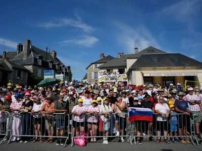 Spectators wait for the riders to pass during the ninth stage of the Tour de France cycling race with start in Malemort and finish in Ussel, France, Sunday, July 12, 2026. (AP Photo/Mosa'ab Elshamy)