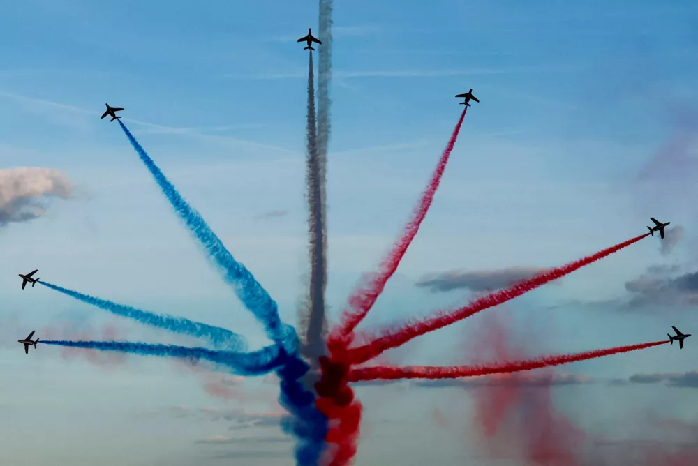 Aircrafts of the Patrouille de France fly over Paris during a parade at the Champs-Elysees avenue for all the French athletes who participated in the 2024 Olympics and Paralympics, in Paris, France September 14, 2024. REUTERS/Gonzalo Fuentes/Pool   TPX IMAGES OF THE DAY