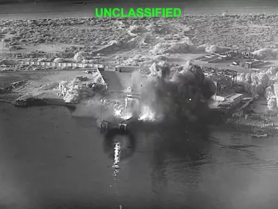 This image from video released by U.S. Central Command, shows an explosion at Bandar Abbas Naval Base, Iran, as three Corsair unmanned surface vessels, also called one-way attack surface drones, fired by the U.S. military, hit the port July 12, 2026. (U.S. Central Command via AP)