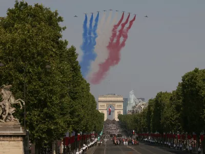 Jets from the acrobatic Patrouille de France fly during the Bastille Day military parade on the Champs-Elysees avenue in Paris, Tuesday, July 14, 2026. (AP Photo/Thomas Padilla)