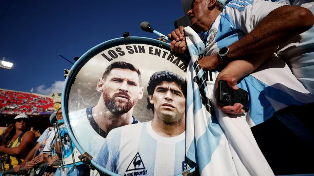 FILE PHOTO: Soccer Football - FIFA World Cup 2026 - Quarter Final - Argentina v Switzerland - Kansas City Stadium, Kansas City, Missouri, U.S. - July 11, 2026 Argentina fans play drums displaying Lionel Messi and Diego Maradona inside the stadium before the match REUTERS/Lee Smith/File Photo