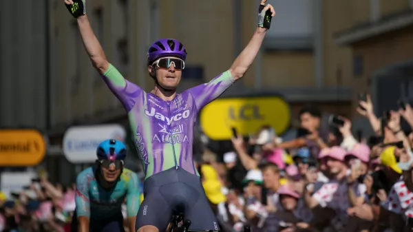 Switzerland's Mauro Schmid celebrates as he crosses the finish line to win the thirteenth stage of the Tour de France cycling race with start in Dole and finish in Belfort, France, Friday, July 17, 2026. (AP Photo/Mosa'ab Elshamy)