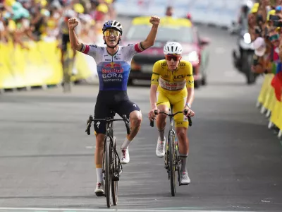 Belgium's Remco Evenepoel celebrates as he crosses the finish line ahead Slovenia's Tadej Pogacar to win the fifteenth stage of the Tour de France cycling race, from Champagnole to the Plateau de Solaison, France, Sunday, July 19, 2026. (AP Photo/Thibault Camus)