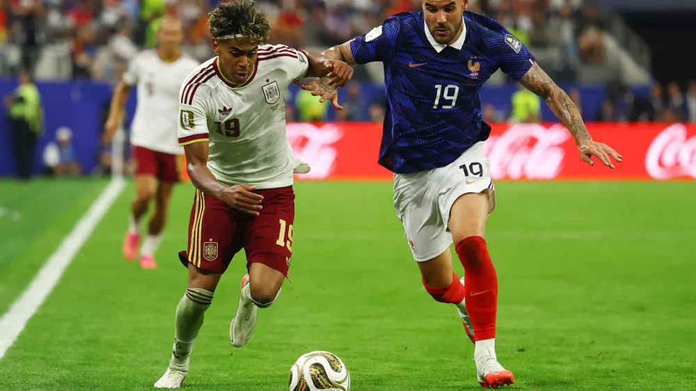 Soccer Football - FIFA World Cup 2026 - Semi Final - France v Spain - Dallas Stadium, Arlington, Texas, U.S. - July 14, 2026 Spain's Lamine Yamal in action with France's Theo Hernandez REUTERS/Hannah Mckay