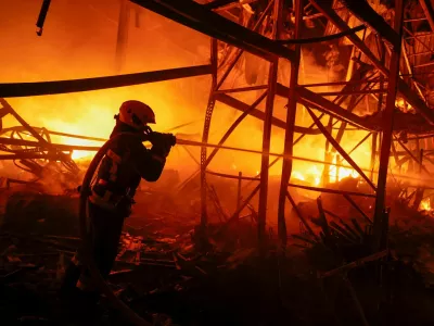 A firefighter works at a compound of a warehouse damaged during Russian missile strikes, amid Russia's attack on Ukraine, in Kyiv, Ukraine July 16, 2026. REUTERS/Valentyn Ogirenko   TPX IMAGES OF THE DAY